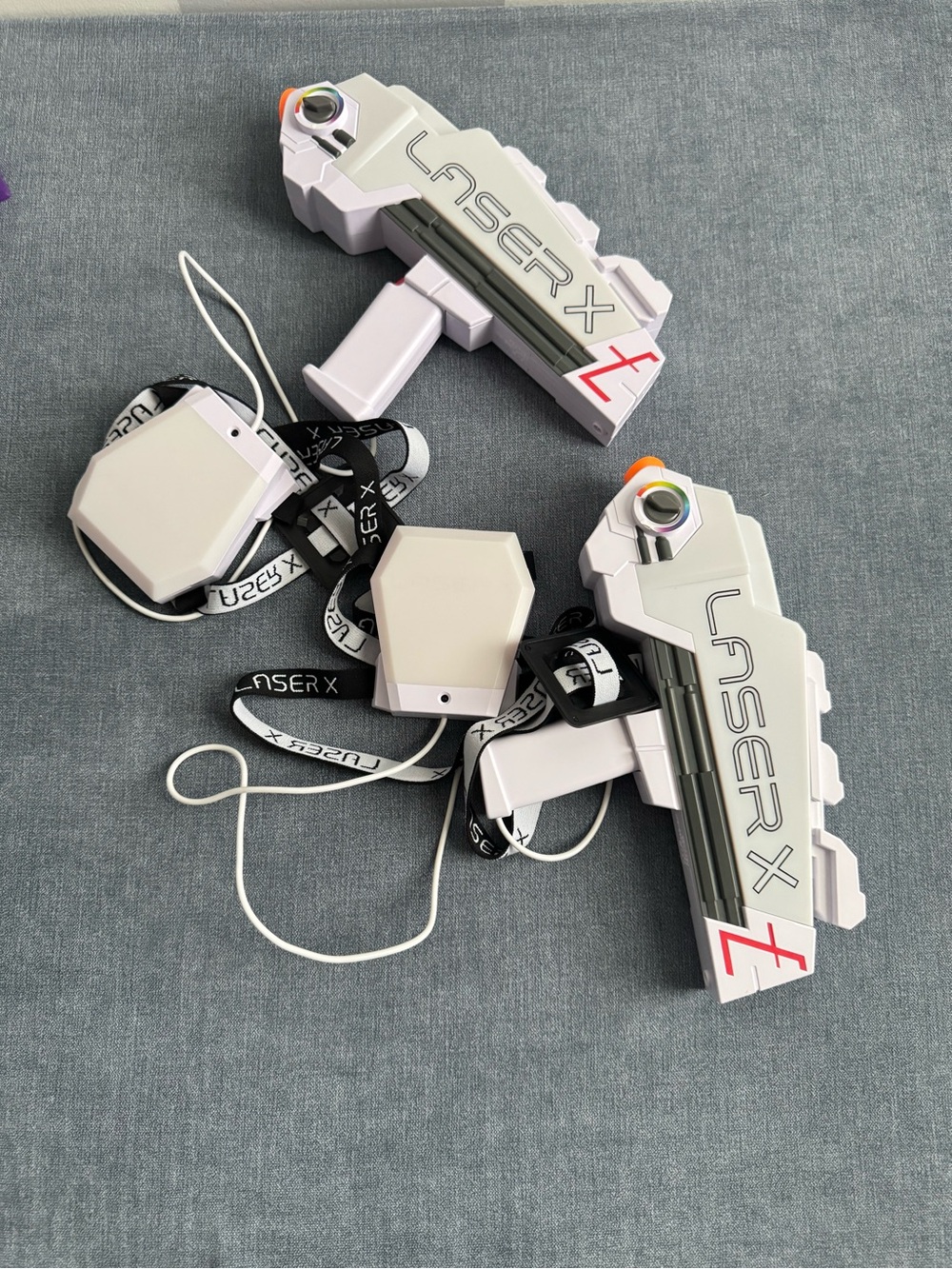 Laser X Revolution blasters and two white receiver vests.